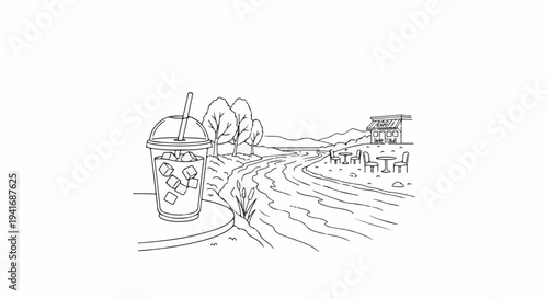 Iced drink on a table overlooking a river and a cafe