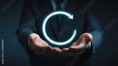 Businessperson holding hands beneath a glowing circular arrow symbol representing continuous process, refresh, or digital transformation in a futuristic technology concept.