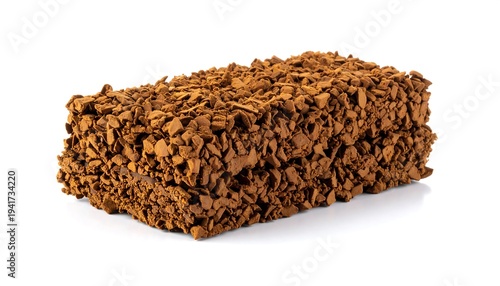 Rectangular brick-shaped object covered in small, dark brown granular particles, against a white background