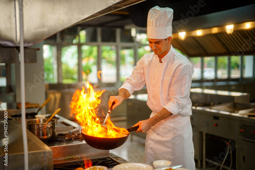 Foto Professional chef cooking with intense flames in a commercial kitchen setting