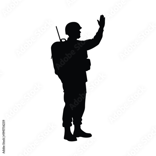 Soldier in silhouette with hand raised and backpack on