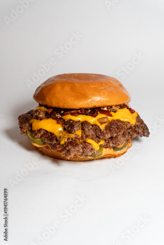 Foto Classic double smash cheeseburger with pickles and special sauce on a toasted br