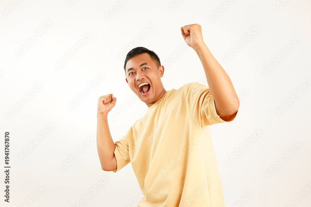 Fototapeta premium Portrait of Asian Man with Excited Expression and Victory Gesture Isolated on White Background