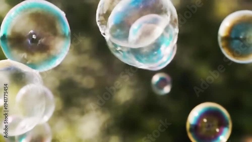Close Up View Of Iridescent Soap Bubbles Floating In The Air Outdoors With Shallow Depth Of Field Capturing Vibrant Colors Reflecting Sunlight