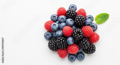 Fresh berries arrangement on white background for culinary or health concepts