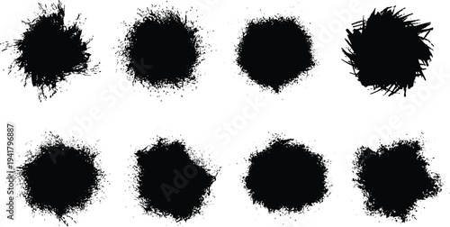 Collection of eight black smudge stains on white background