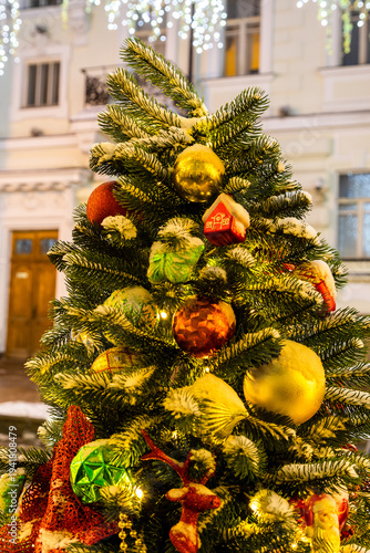 Photography christmas tree decorated with toys on street