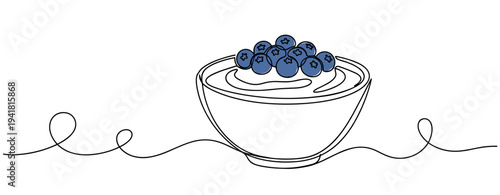 Bowl of yogurt topped with blueberries on continuous line