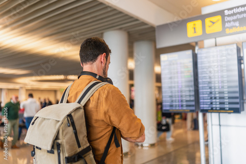 Traveler checking flight departure information at airport