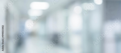 Wallpaper Mural A blurred view of a hospital corridor featuring lights and glass panels. The scene conveys a sense of space and health care environment without clear details. Torontodigital.ca