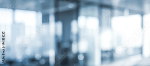 Wallpaper Mural An office interior with large glass windows showcasing a city skyline in the background. The view is blurred, creating a modern and sleek environment. Torontodigital.ca