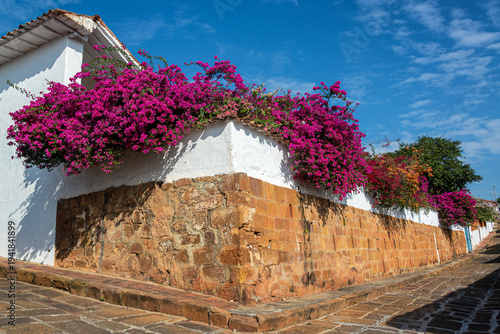 Barichara street with colorful bougainvillea adorning colonial architecture