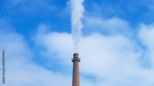 smoke is coming up from brick industrial chimney, slow motion
