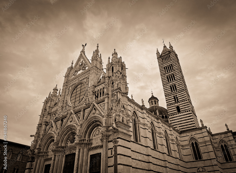 Obraz premium Siena Cathedral facade and bell tower under overcast sky, Tuscany, Italy