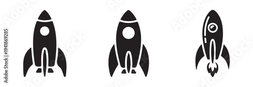 Set of three solid black filled rocket ship icons one tilted in flight with engine thrust visible and two upright