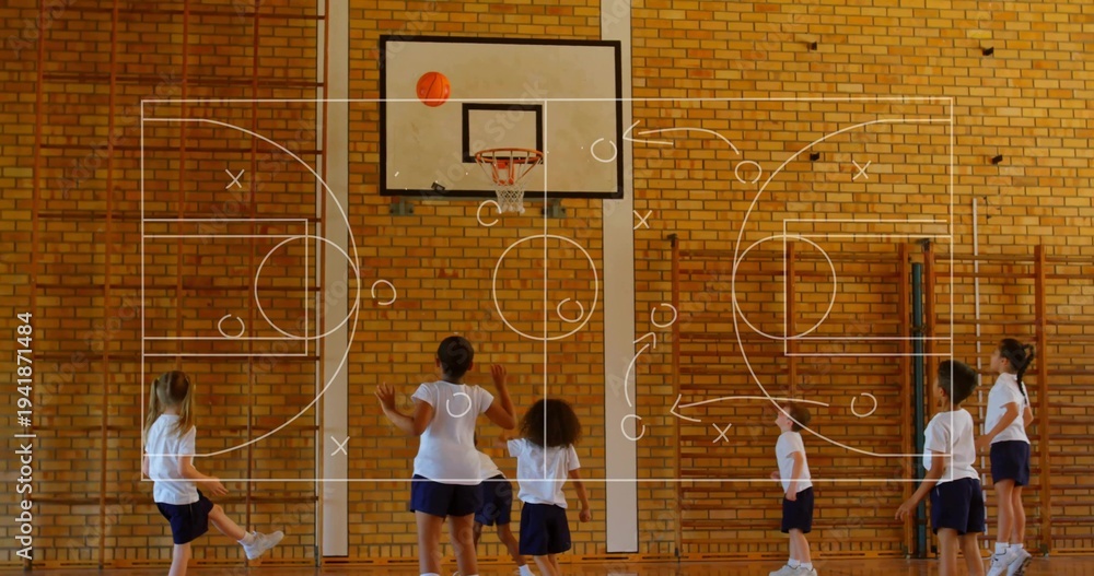 Obraz premium Playing kids in white Ts navy shorts reaching for basketball above hoop in school-gym, X or O overla