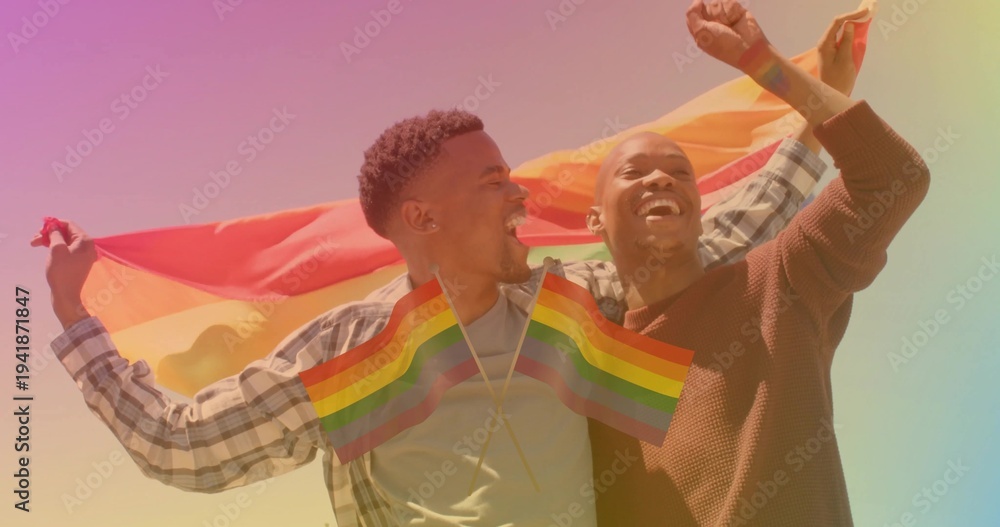 Naklejka premium Holding pride flag, couple wearing plaid and brown sweater in field with crossed flags at chest
