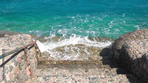 stone staircase to the sea with turquoise water, slow motion
