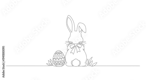 Easter bunny with decorated egg and bowtie