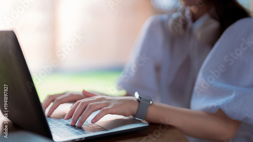 Bilde på lerret Asian adult woman typing laptop keyboard remote work online study modern technol