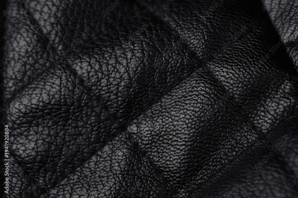 Obraz premium Detailed close up view of dark elegant black leather texture surface with unique creases and patterns