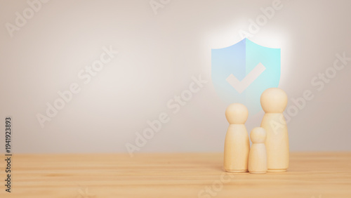 Photos Family protection concept using wooden figurines and security shield representing life insurance, financial safety and long term savings planning for household stability