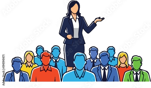 A female speaker addresses a diverse group of people in a meeting