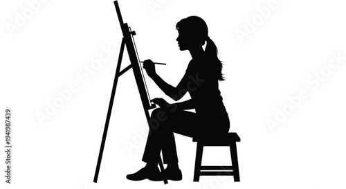 Artist painting at an easel a striking black silhouette