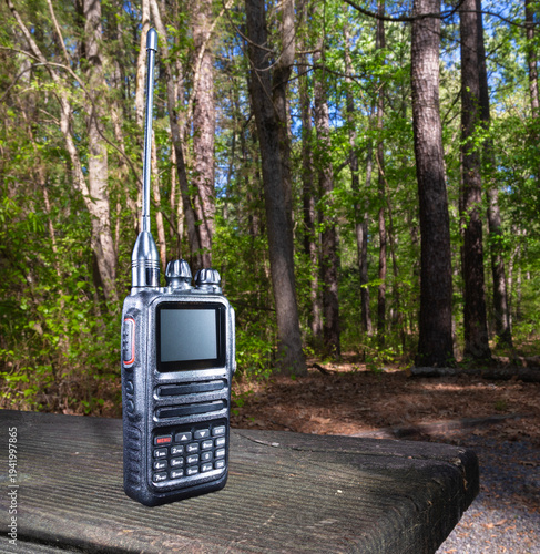 Black modern walkie talkie in a forest