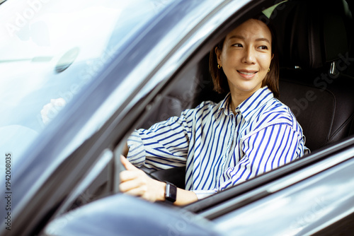 Korean woman sits in car an...