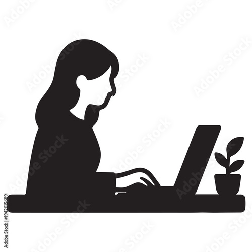 Focused woman working diligently on a laptop computer at a desk.