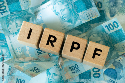 IRPF, Imposto de Renda de Pessoa Física, English translation Personal Income Tax. Financial concept. Taxes in Brazil. written on wooden blocks, Brazilian money, calculator, business background