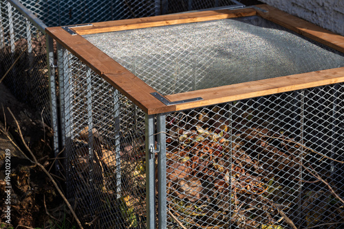 Recycled garden habitat. Weathered metal enclosure filled with organic debris