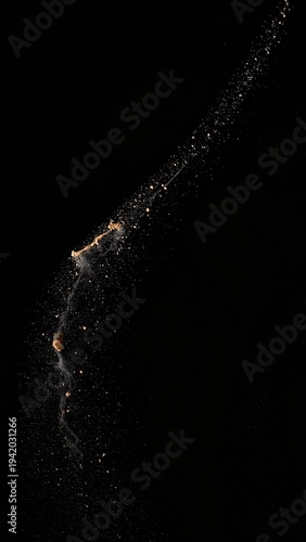 Wallpaper Mural A striking long-exposure photograph captures the dynamic arc of flour or spice particles suspended in mid-air against a stark black background, creating an abstract. Torontodigital.ca