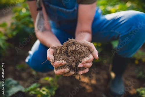 Tableau sur toile Close up of female famer hands holding soil outdoors at community farm