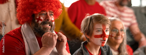 Fotografi Excited football fans supproting English national team in live soccer match at stadium