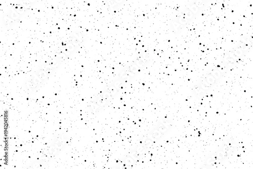 A dynamic composition of small black imperfections dispersed over a pristine light colored sheet