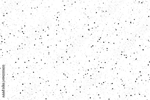 A speckled white surface with numerous tiny black dots resembling a dusty granular texture