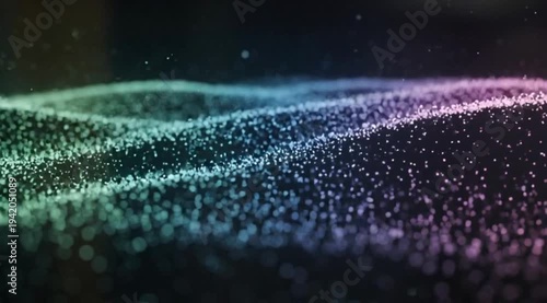 Abstract cinematic motion of glowing digital particles forming colorful green and purple waves on a dark background with shallow depth of field and bokeh light effects