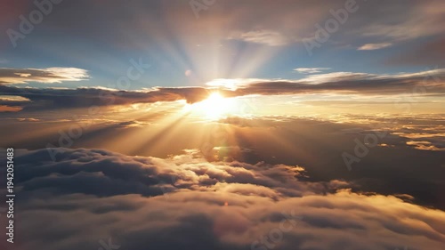 Aerial view of breathtaking sunrise above clouds, golden sun rays shining through, 4k video footage