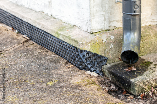 Foundation Waterproofing Membrane With Downspout Drainage System Protecting Building Base