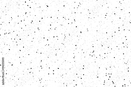 Randomly dispersed black particles create an aged effect on a smooth white surface