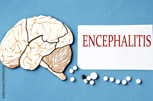 ENCEPHALITIS - word on white sheet on blue background and skull mockup