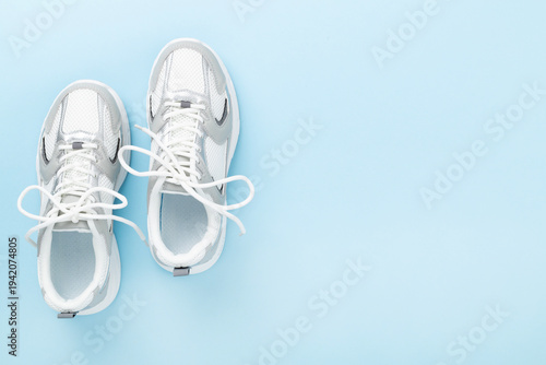 Slika na platnu Pair of sneakers on color background, top view