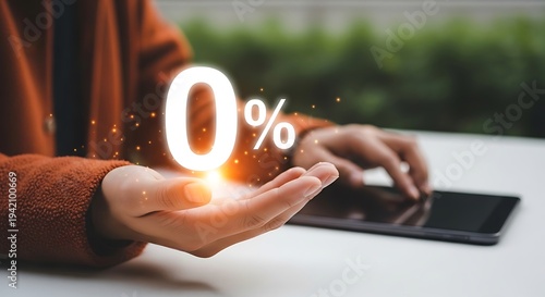 A person holding a glowing 0 icon above a laptop keyboard on a white table outdoors