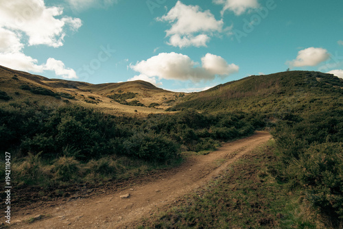 View to Pentlands - Scottish landscape with hills covered by grass and moss. Low sky with dramatic clouds.