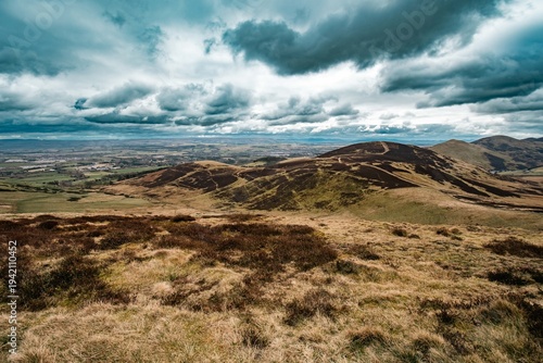 View to Pentlands - Scottish landscape with hills covered by grass and moss. Low sky with dramatic clouds.
