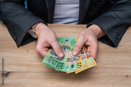 Wallpaper Mural Businessman Hands Counting Fifty and One Hundred Australian Dollar Banknotes on Wooden Table Torontodigital.ca