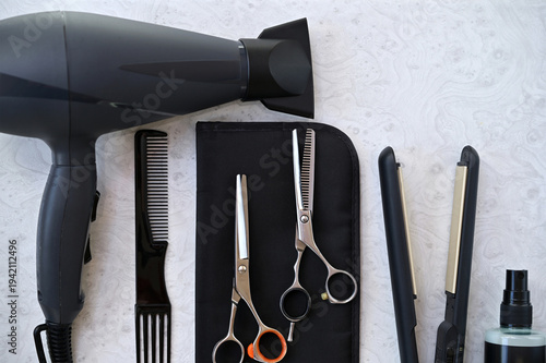 Photography Professional hairdressing tools flat lay with hair dryer, scissors and comb