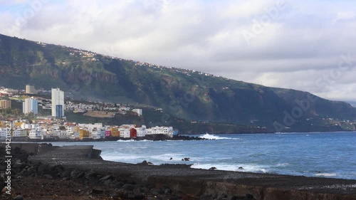 North coast of Tenerife at Punta Brava, part of Puerto de la Cruz, with strong Atlantic waves crashing against the pier along the rugged shoreline of the Canary Islands